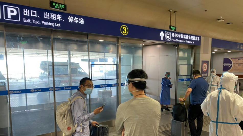 China halves quarantine time for overseas travellers